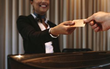 Businessman paying for hotel room at reception