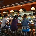 Customers at a tapas bar at La Boqueria market in Barcelona, Spain