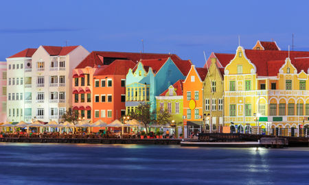 View of downtown Willemstad at twilight. Curacao, Netherlands Antilles (Photo via sorincolac / iStock / Getty Images Plus)