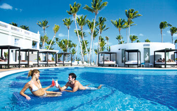 Couple cheers in the pool in Punta Cana
