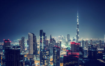 Beautiful Dubai cityscape, bird&#39;s eye view on a night urban scene, modern city panoramic landscape, United Arab Emirates (photo via Anna_Om / iStock / Getty Images Plus)