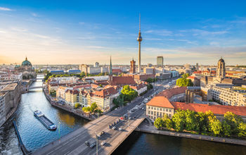 Aerial view of Berlin skyline with famous TV tower and Spree river in beautiful evening light at sunset, Germany. (photo via bluejayphoto/iStock/Getty Images Plus)
