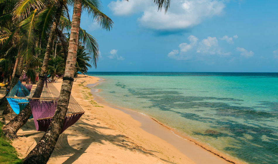 tropical beach with hammock on palm, relax concept from Nicaragua (Photo via riderfoot / iStock / Getty Images Plus)