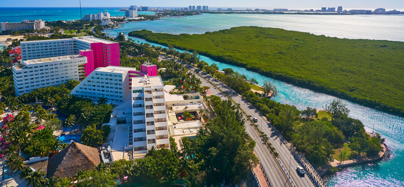Image: An aerial view of Cancun's Hotel Zone at Playa Linda. (photo via LUNAMARINA / iStock / Getty Images Plus)