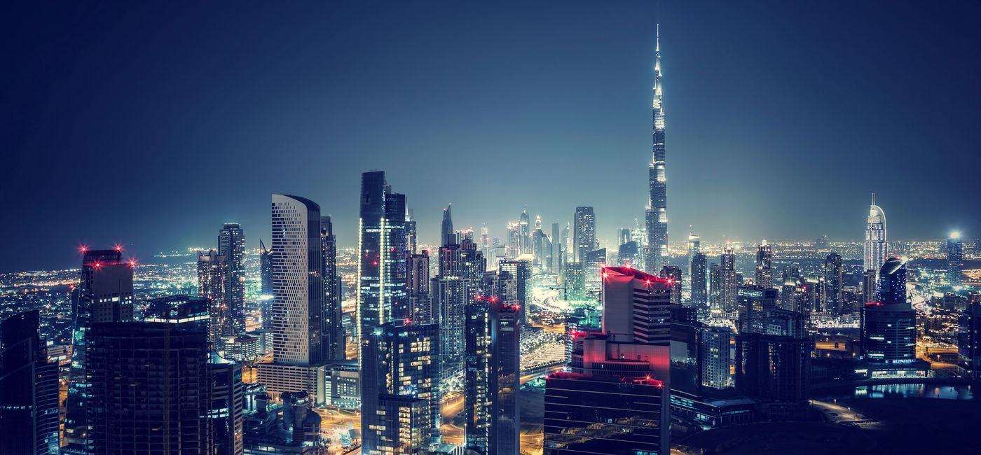 Image: Beautiful Dubai cityscape, bird's eye view on a night urban scene, modern city panoramic landscape, United Arab Emirates (photo via Anna_Om / iStock / Getty Images Plus)