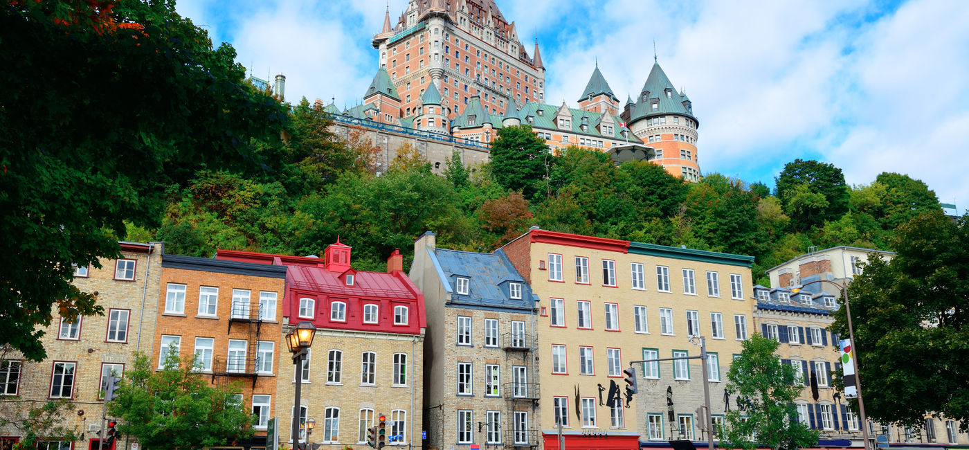 Image: Chateau Frontenac in the day with colorful buildings on street in Quebec City (Photo via rabbit75_ist / iStock / Getty Images Plus)