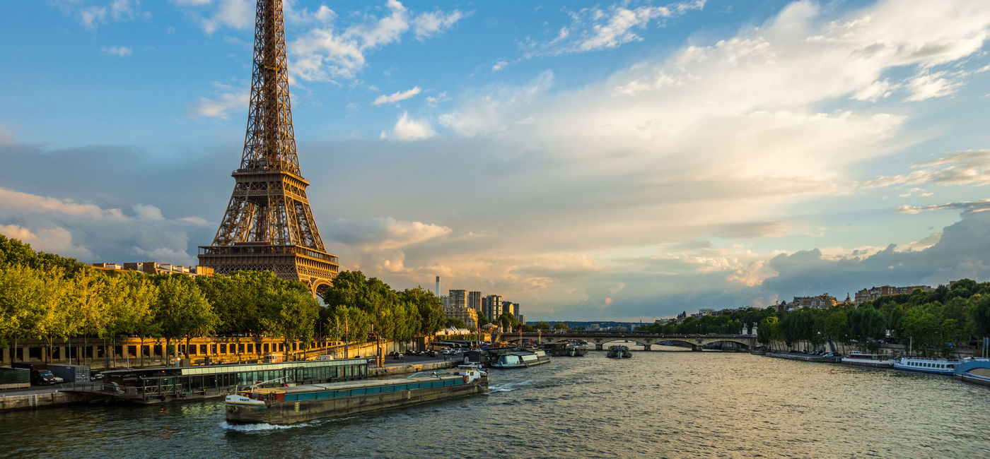 Image: Eiffel Tower and Seine river. (photo via gbarm/ iStock / Getty Images Plus)