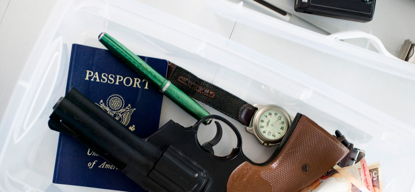 Image: Gun in airport screening tray. (photo via Creatas / Creatas / Getty Images Plus)