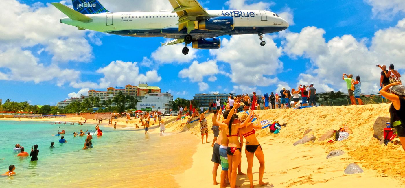 Image: JetBlue flight landing at Princess Juliana International Airport in St. Maarten. (photo via Marina113/iStock Editorial/Getty Images Plus)