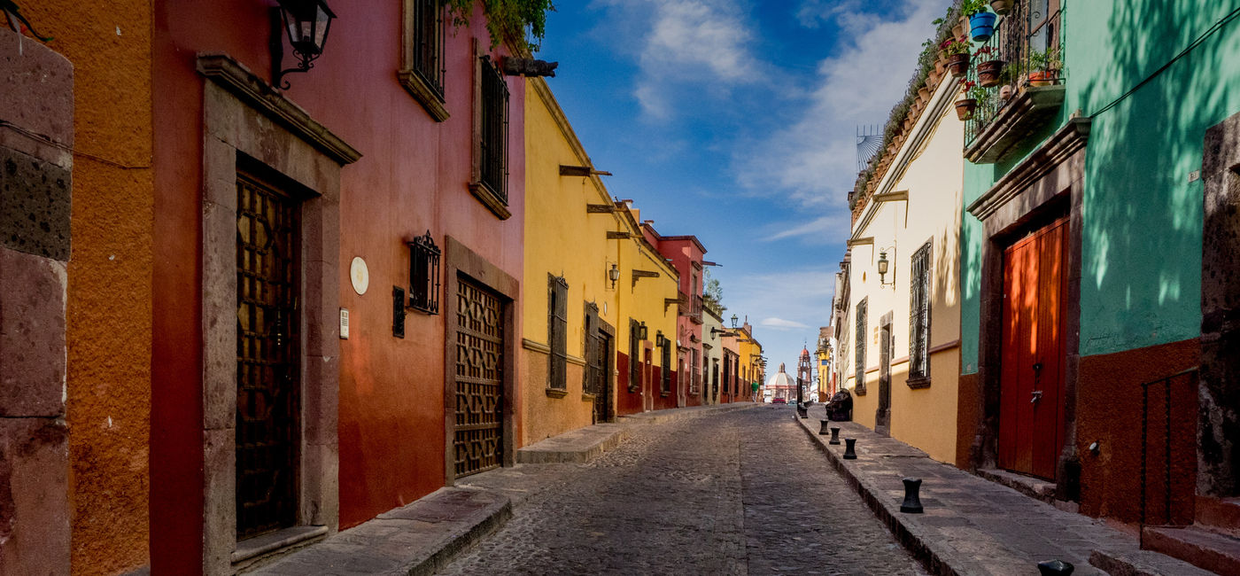 Image: The many backstreets of San Miguel de Allende in Mexico can be quiet, colorful and beautifully preserved. A wonderful serene place for a morning or evening walk. (photo via thupton / iStock / Getty Images Plus)