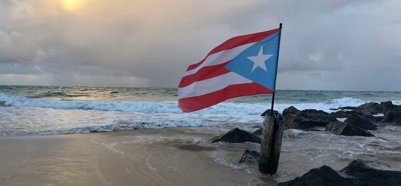 Image: The Puerto Rico flag flaps in the breeze on the beach near San Juan's La Concha Resort. (photo by Paul Heney) (Photo by Paul Heney.)