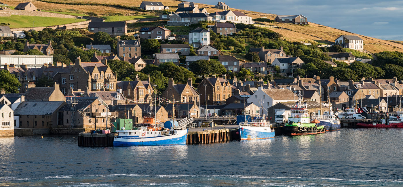 Image: The village of Stromness as seen from the sea.  (Photo Credit: Nicola Colombo / iStock / Getty Images Plus)