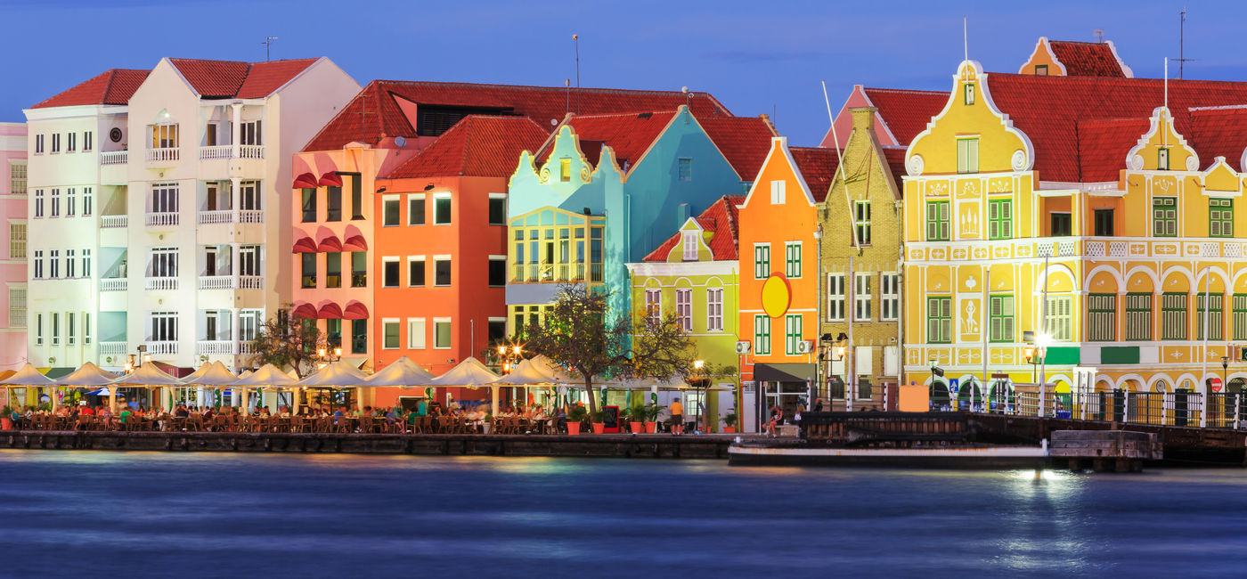Image: View of downtown Willemstad at twilight. Curacao, Netherlands Antilles (Photo via sorincolac / iStock / Getty Images Plus)