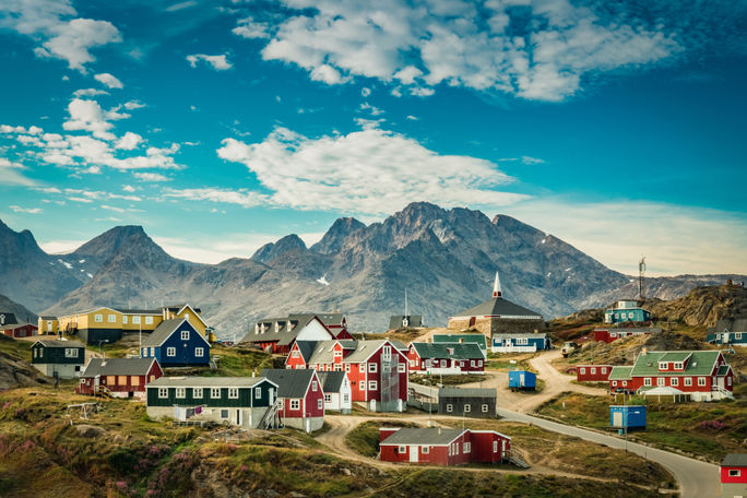 view of a colorful village in Greenland (photo via Elizabeth M. Ruggiero/iStock/Getty Images Plus)