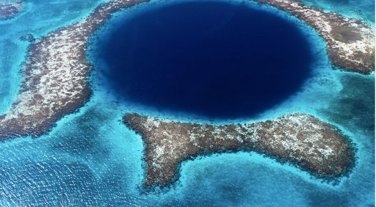 The magnificent Blue Hole is one of the natural wonders that Belize offers its visitors. (Lomingen / iStock / Getty Images Plus).