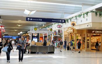 Passengers walking by shops at Minneapolis-St Paul International Airport